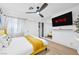 Bright bedroom featuring a ceiling fan, closet with mirrored doors, and a large, wall-mounted television at 2728 Monrovia Dr, Las Vegas, NV 89117