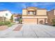 Charming stucco home featuring a three-car garage and well-manicured landscaping at 2728 Monrovia Dr, Las Vegas, NV 89117