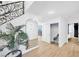 Hallway with a large mirror, plant in a black pot, and a closet with a baby chair at 2728 Monrovia Dr, Las Vegas, NV 89117