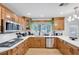 Well-lit kitchen featuring wood cabinets, stainless appliances, and quartz countertops at 2728 Monrovia Dr, Las Vegas, NV 89117