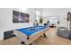 Living area with a pool table and a view into the dining area with modern black furniture at 2728 Monrovia Dr, Las Vegas, NV 89117