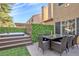 Backyard patio with outdoor dining, a hot tub, and privacy greenery at 2728 Monrovia Dr, Las Vegas, NV 89117