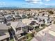 An aerial view of a community featuring houses with desert landscaping and mountain views at 2740 Aldine Ct, Las Vegas, NV 89142