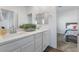 Bathroom with double vanity and white cabinets with a view into bedroom at 2740 Aldine Ct, Las Vegas, NV 89142