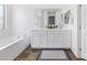 Elegant bathroom featuring a double vanity, stylish tile flooring, and a soaking tub at 2740 Aldine Ct, Las Vegas, NV 89142