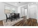 Bright dining room with dark wood floors and a table with black chairs at 2740 Aldine Ct, Las Vegas, NV 89142