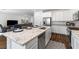 Modern kitchen with granite countertops, stainless steel appliances and breakfast bar overlooking the living room at 2740 Aldine Ct, Las Vegas, NV 89142