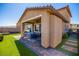 This backyard boasts a covered patio, artificial grass, and paver landscaping at 306 Dedication Ave, Henderson, NV 89011