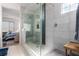 Modern bathroom with a tiled walk-in shower and a bench, offering a spa-like experience at 306 Dedication Ave, Henderson, NV 89011