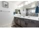 Modern bathroom features double sinks, gray cabinets, and a large mirror for a clean, elegant design at 306 Dedication Ave, Henderson, NV 89011