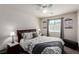 Cozy bedroom with a patterned duvet, bedside lamps, and a window with natural light at 306 Dedication Ave, Henderson, NV 89011