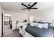 Comfortable bedroom displays a ceiling fan, neutral walls, and a well-lit open doorway to a connected room at 306 Dedication Ave, Henderson, NV 89011