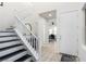 Bright foyer with staircase, tiled floors, and a view into a home office with a ceiling fan at 306 Dedication Ave, Henderson, NV 89011