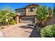 Charming two-story home with brick driveway, stone accents, lush trees, and a well-manicured lawn at 306 Dedication Ave, Henderson, NV 89011