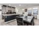 Modern kitchen with granite countertops, dark backsplash, and stainless steel appliances; open to the dining area at 306 Dedication Ave, Henderson, NV 89011