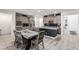 Stylish kitchen and dining area featuring granite countertops, stainless steel appliances, and tile flooring at 306 Dedication Ave, Henderson, NV 89011