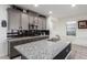 Modern kitchen features granite countertops, stylish gray cabinetry, and stainless steel appliances at 306 Dedication Ave, Henderson, NV 89011