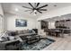 Open living room leading to dining area and kitchen with a large ceiling fan and tile flooring at 306 Dedication Ave, Henderson, NV 89011