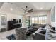 Bright living room featuring a large ceiling fan, modern furniture, and access to the outdoor patio at 306 Dedication Ave, Henderson, NV 89011