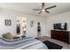 Bright main bedroom with a ceiling fan, ensuite bathroom, and walk-in closet at 306 Dedication Ave, Henderson, NV 89011