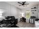 This home office has sleek tile flooring, a modern ceiling fan, and custom shelving at 306 Dedication Ave, Henderson, NV 89011