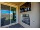 An outdoor patio features a modern fireplace and sliding glass doors at 306 Dedication Ave, Henderson, NV 89011