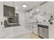 Bright kitchen features stainless steel appliances, light wood flooring and white cabinets with black hardware at 3318 N Decatur Blvd # 2007, Las Vegas, NV 89130