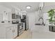 Bright kitchen features stainless steel appliances, light wood flooring and white cabinets with black hardware at 3318 N Decatur Blvd # 2007, Las Vegas, NV 89130