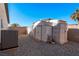 Backyard with multiple storage sheds and an air conditioning unit at 341 Dylan Pl, Pahrump, NV 89048