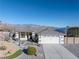 Exterior elevation showing two car garage, xeriscape front yard, and mountain views in the background at 341 Dylan Pl, Pahrump, NV 89048