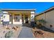 Front entrance showcasing walkway, decorative rock landscape, and covered porch with decorative columns at 341 Dylan Pl, Pahrump, NV 89048