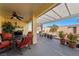 Covered patio featuring comfortable seating and view of the landscaped backyard at 341 Dylan Pl, Pahrump, NV 89048