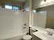 Bathroom with a white tiled shower and white vanity at 4240 Caliper Dr, Las Vegas, NV 89110