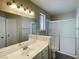 Bathroom with a white vanity, large mirror, and walk-in shower at 4240 Caliper Dr, Las Vegas, NV 89110