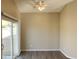 Bedroom with wood floors, ceiling fan and sliding glass door to the backyard at 4240 Caliper Dr, Las Vegas, NV 89110