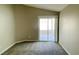 Bright bedroom featuring a sliding glass door and neutral carpeting at 4240 Caliper Dr, Las Vegas, NV 89110