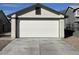 A two car garage with a clean white door and driveway at 4240 Caliper Dr, Las Vegas, NV 89110