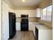 Well-lit kitchen featuring white cabinets and black appliances at 4240 Caliper Dr, Las Vegas, NV 89110