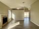 Inviting living room with a fireplace, light wood floors, and view into another room at 4240 Caliper Dr, Las Vegas, NV 89110