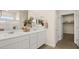 Well-lit bathroom with a double vanity, white cabinets, and a view into the walk-in closet at 4280 E Brusca Way, Pahrump, NV 89061