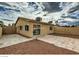 Expansive backyard with concrete patio, rock landscaping, and access gate to the side of the property at 4522 Via San Rafael, Las Vegas, NV 89103