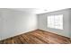 Bright, minimalist bedroom with wood floors and a large window at 4827 S Torrey Pines Dr # 204, Las Vegas, NV 89103