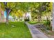 Sidewalk leading through a well-maintained green area between condo buildings, featuring mature trees at 4827 S Torrey Pines Dr # 204, Las Vegas, NV 89103