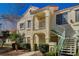 Charming two-story condo exterior with a well-kept lawn and staircase to the upper level entrance at 4827 S Torrey Pines Dr # 204, Las Vegas, NV 89103