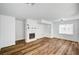 Living room featuring a cozy fireplace, wood floors and bright, white walls at 4827 S Torrey Pines Dr # 204, Las Vegas, NV 89103