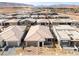 An aerial view showcases a modern home featuring desert landscaping, a brick paver driveway, and a two-car garage at 5015 Terramont Dr, Las Vegas, NV 89135