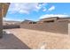 Large, undeveloped lot with partial privacy block wall surrounding the property at 5015 Terramont Dr, Las Vegas, NV 89135