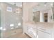 Bright bathroom featuring a glass-enclosed shower and white cabinets at 5015 Terramont Dr, Las Vegas, NV 89135