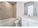 Modern bathroom with a tiled shower-tub combo, white vanity, and stylish fixtures at 5015 Terramont Dr, Las Vegas, NV 89135