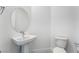 Modern powder room featuring a vessel sink, round mirror, and sleek fixtures at 5015 Terramont Dr, Las Vegas, NV 89135